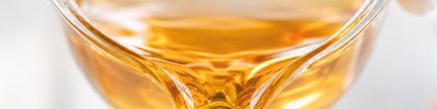 Fötales Kälberserum (mit charakteristisch goldener Farbe) wird von einem Becherglas umgefüllt